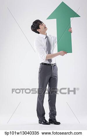 a business man holding an arrow View Large Photo Image Stock Photography - a business man holding an arrow. Fotosearch