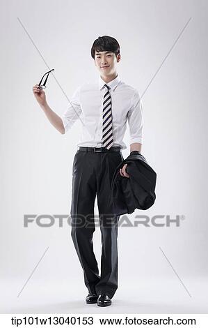a business man holding his glasses View Large Photo Image Stock Image - a business man holding his glasses. Fotosearch