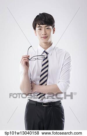 a business man holding his glasses View Large Photo Image Stock Photo - a business man holding his glasses. Fotosearch
