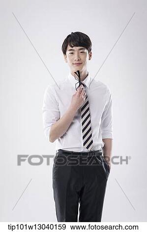 a business man holding his glasses View Large Photo Image Stock Photo - a business man holding his glasses. Fotosearch