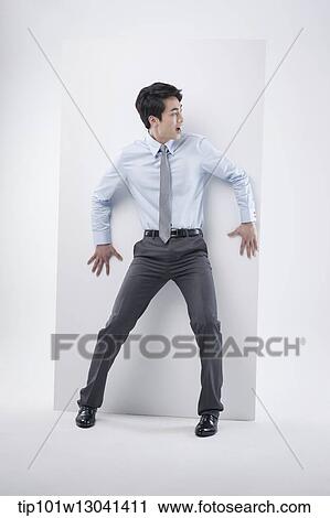 Stock Image - a business man leaning at a block. Fotosearch