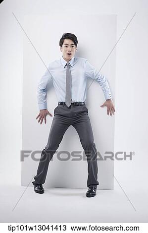 Stock Image - a business man leaning at a block. Fotosearch
