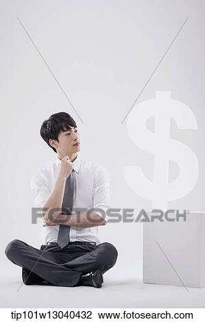 a business man next to a dollar sign View Large Photo Image Stock Image - a business man next to a dollar sign. Fotosearch