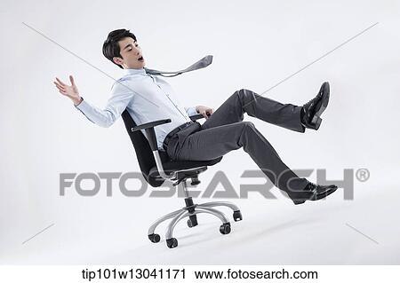 a business man playing with a chair View Large Photo Image Stock Image - a business man playing with a chair. Fotosearch