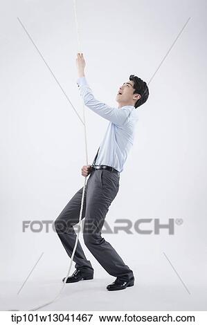 a business man pulling a wire View Large Photo Image Stock Photo - a business man pulling a wire. Fotosearch
