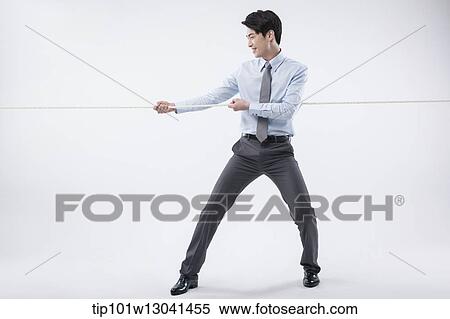 a business man pulling a wire View Large Photo Image Stock Photography - a business man pulling a wire. Fotosearch