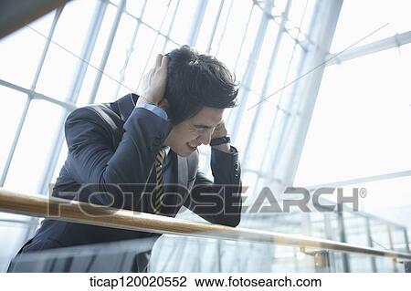 Stock Image - a business man scratching his head. Fotosearch