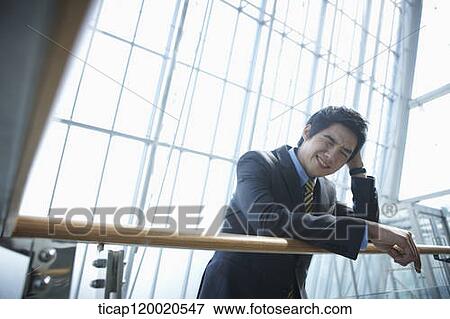 Stock Photo - a business man scratching his head. Fotosearch