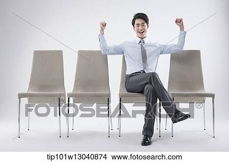 Picture - a business man sitting on a chair. Fotosearch