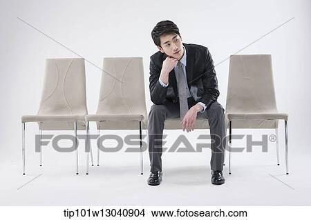 Picture - a business man sitting on a chair. Fotosearch