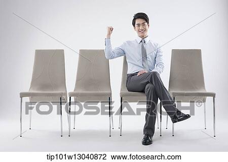 Stock Image - a business man sitting on a chair. Fotosearch