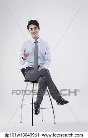 a business man sitting on a chair View Large Photo Image Stock Image - a business man sitting on a chair. Fotosearch