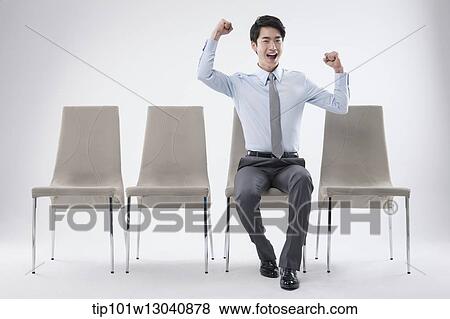 Stock Photo - a business man sitting on a chair. Fotosearch