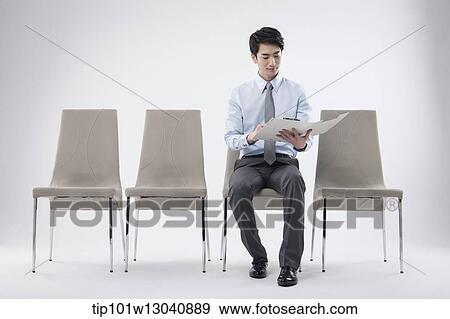 a business man sitting on a chair View Large Photo Image Stock Photo - a business man sitting on a chair. Fotosearch