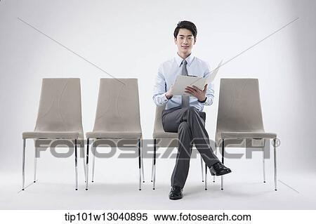 Stock Photography - a business man sitting on a chair. Fotosearch