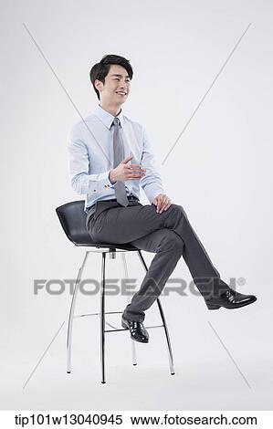 a business man sitting on a chair View Large Photo Image Stock Photography - a business man sitting on a chair. Fotosearch