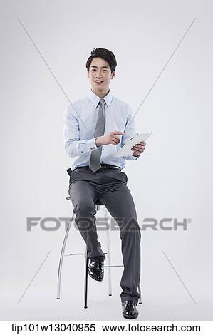 Stock Photography - a business man sitting on a chair. Fotosearch