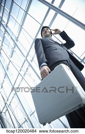 Picture - a business man talking on the phone. Fotosearch