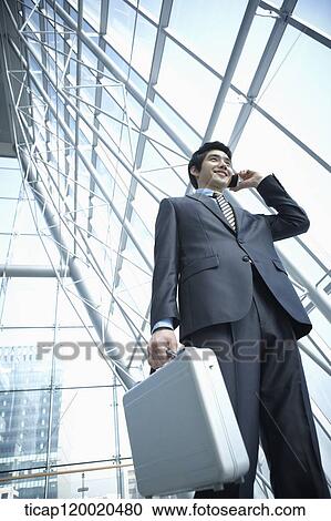 a business man talking on the phone View Large Photo Image Stock Image - a business man talking on the phone. Fotosearch