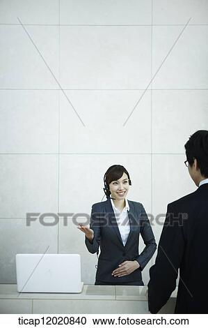 a business man talking to the receptionist View Large Photo Image Stock Image - a business man talking to the receptionist. Fotosearch