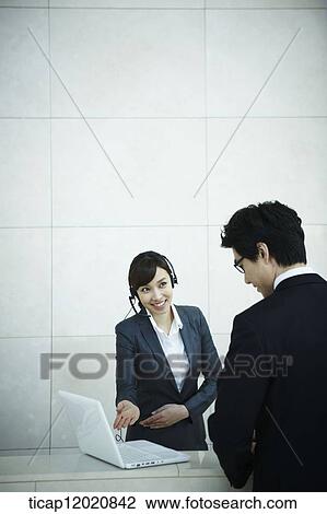 a business man talking to the receptionist View Large Photo Image Stock Image - a business man talking to the receptionist. Fotosearch