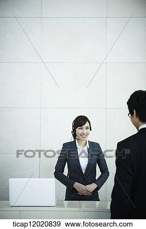 a business man talking to the receptionist View Large Photo Image Stock Photo - a business man talking to the receptionist. Fotosearch