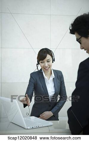 a business man talking to the receptionist View Large Photo Image Stock Photo - a business man talking to the receptionist. Fotosearch