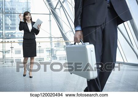 a business man walking away from a woman View Large Photo Image Picture - a business man walking away from a woman. Fotosearch
