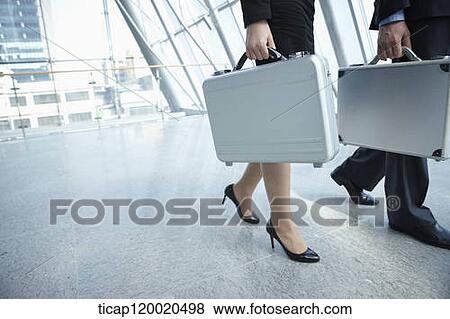 Stock Photo - a business man walking with a business woman. Fotosearch