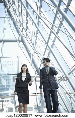 a business man walking with a business woman View Large Photo Image Stock Photo - a business man walking with a business woman. Fotosearch