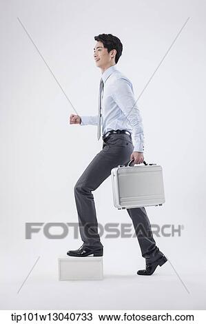Stock Image - a business man with a case. Fotosearch