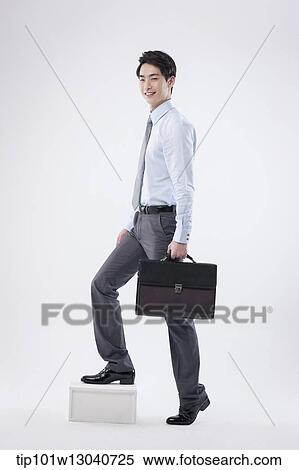 Stock Photography - a business man with a case. Fotosearch