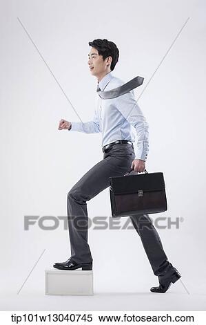 Stock Photography - a business man with a case. Fotosearch