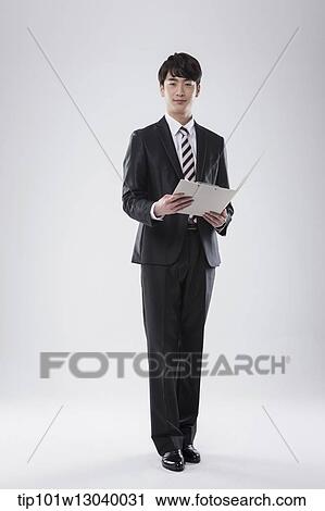 Stock Image - a business man with a folder. Fotosearch