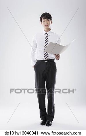 Stock Image - a business man with a folder. Fotosearch