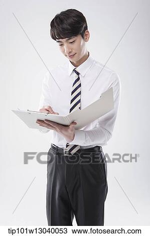 Stock Image - a business man with a folder. Fotosearch