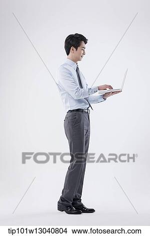 Picture - a business man with a laptop. Fotosearch