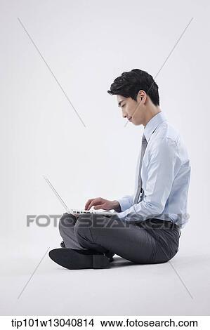 Picture - a business man with a laptop. Fotosearch