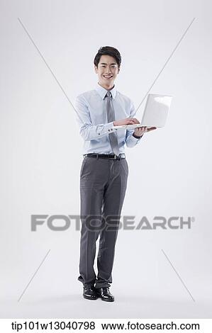 Stock Photo - a business man with a laptop. Fotosearch