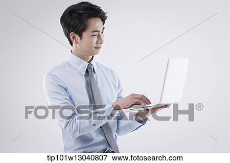 Stock Photo - a business man with a laptop. Fotosearch