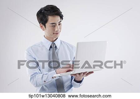 a business man with a laptop View Large Photo Image Stock Photo - a business man with a laptop. Fotosearch