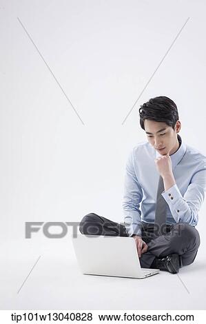 Stock Photo - a business man with a laptop. Fotosearch