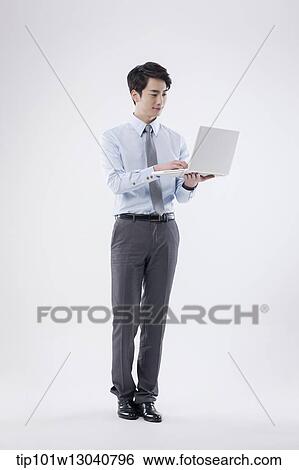 Stock Photograph - a business man with a laptop. Fotosearch