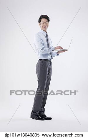 a business man with a laptop View Large Photo Image Stock Photography - a business man with a laptop. Fotosearch