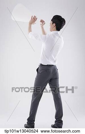 Picture - a business man with a paper megaphone. Fotosearch