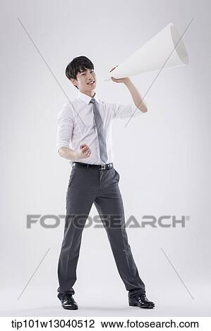 Stock Image - a business man with a paper megaphone. Fotosearch