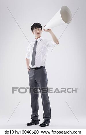 Stock Image - a business man with a paper megaphone. Fotosearch