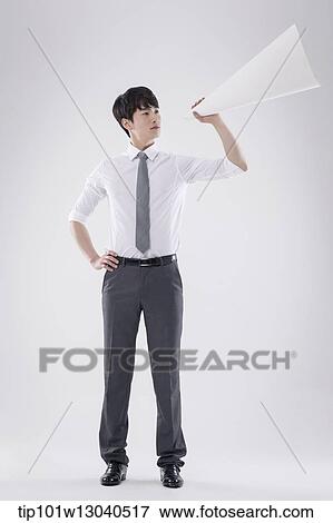 Stock Photo - a business man with a paper megaphone. Fotosearch