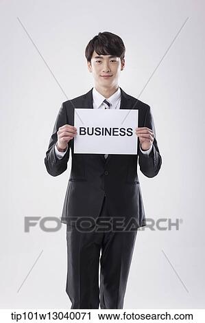 a business man with a paper saying business View Large Photo Image Stock Image - a business man with a paper saying business. Fotosearch