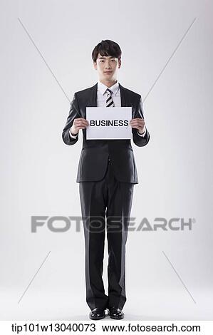 a business man with a paper saying business View Large Photo Image Stock Image - a business man with a paper saying business. Fotosearch